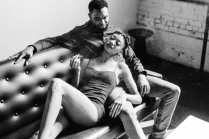 A man and woman lying on a couch enjoying a Delta 8 joint