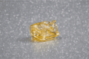 Yellow cannabis diamond on a grey surface