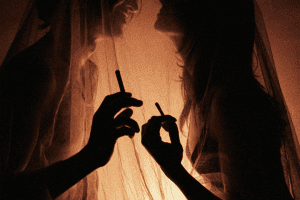 A couple smoking cannabis with soft backlight