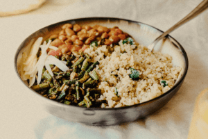 Delicious quinoa with rajma and vegetables in a pot, placed on a white surface - a nutritious and flavorful meal