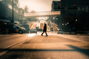 Scenic road in Kentucky with cars and a lady crossing the street