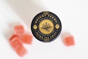 A few Delta-11 THC gummies lay scattered around a container.